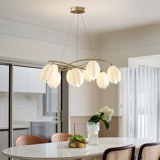 French Magnolia LED Chandelier in cream finish hanging above a modern dining table, showcasing elegant petal-shaped lights for stylish interiors.