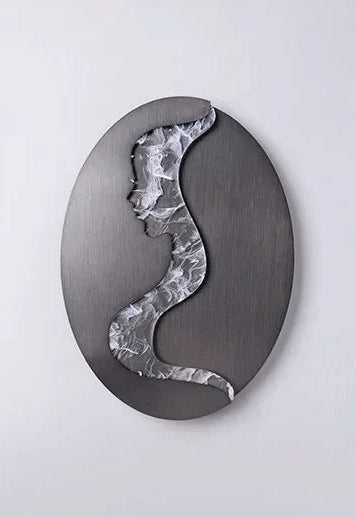 Abstract face wall sconce