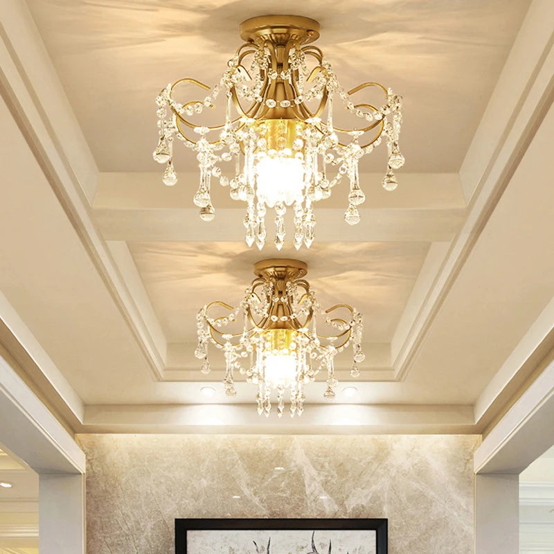 Pair of gold crystal chandeliers with vintage design, ideal for luxury apartment or hotel ceiling lighting fixtures.