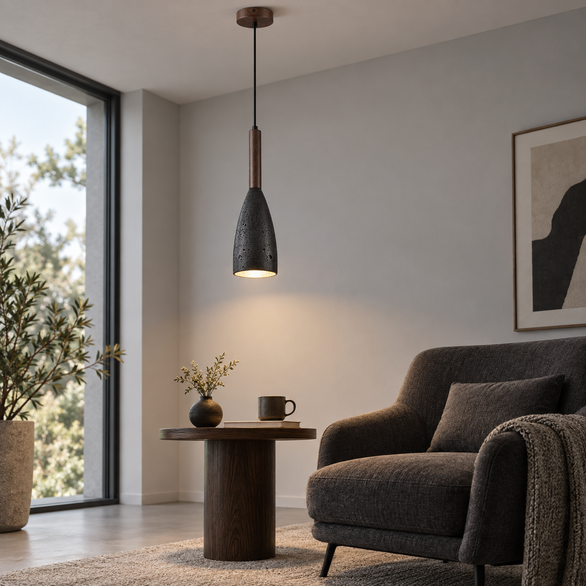 Black stone pendant with walnut accent installed beside a lounge chair, side view