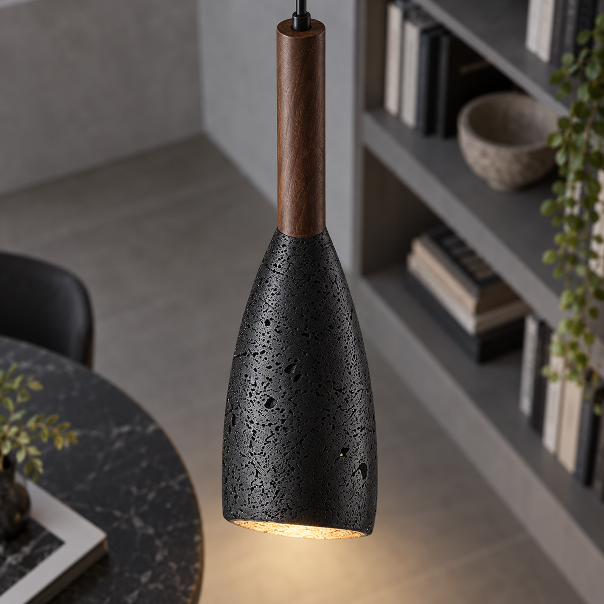 Close-up of the black stone shade and walnut stem of the pendant light