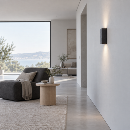 Black stone wall light installed beside a minimalist living room, viewed from the right side
