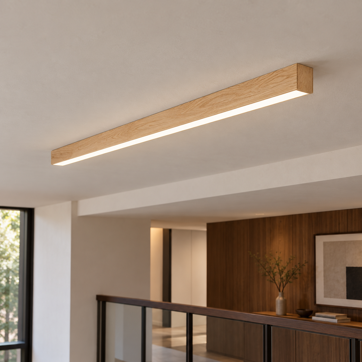 Slim light wood ceiling bar mounted beneath a hallway soffit