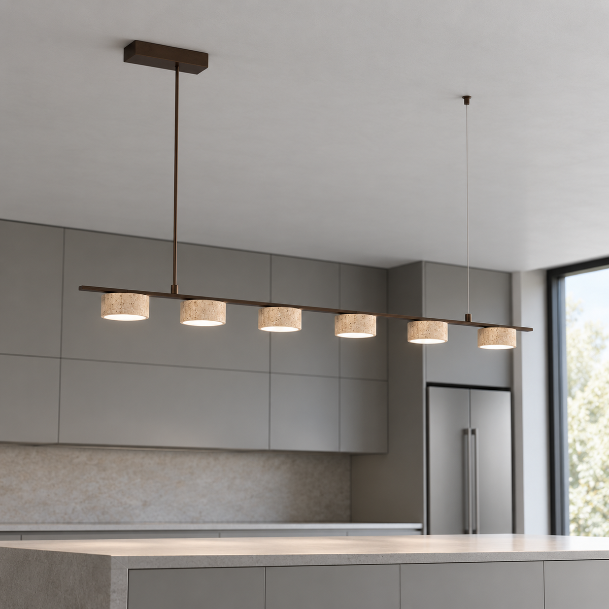 Six-light beige stone pendant viewed from below above a gray kitchen island in neutral daylight