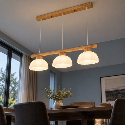 Low angle view beneath the three white glass domes of the wood pendant