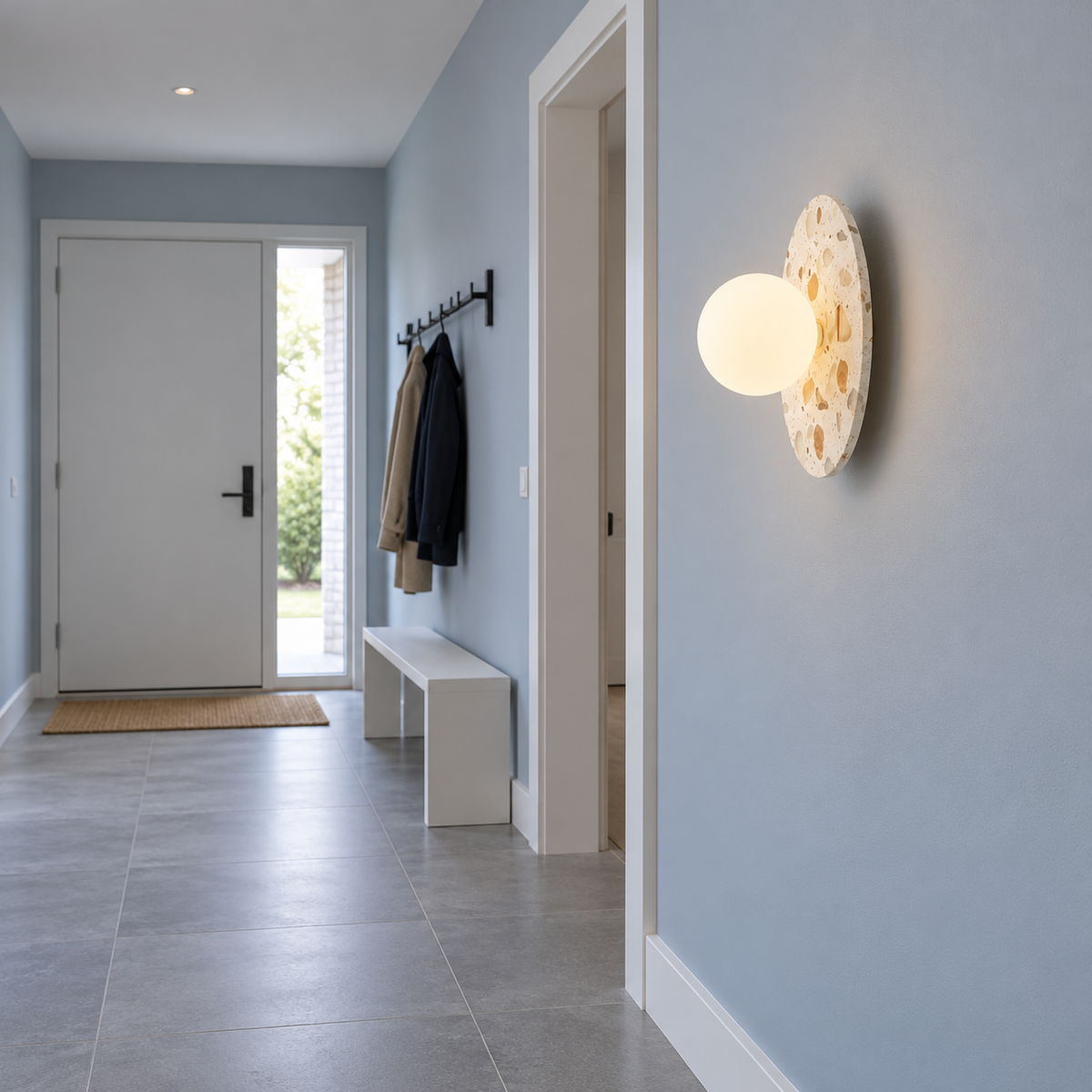 Terrazzo disc wall light with a frosted glass globe — side far, White