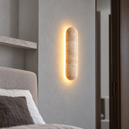 Capsule travertine wall light with a soft halo — commercial, Yellow-beige / Length 30 cm