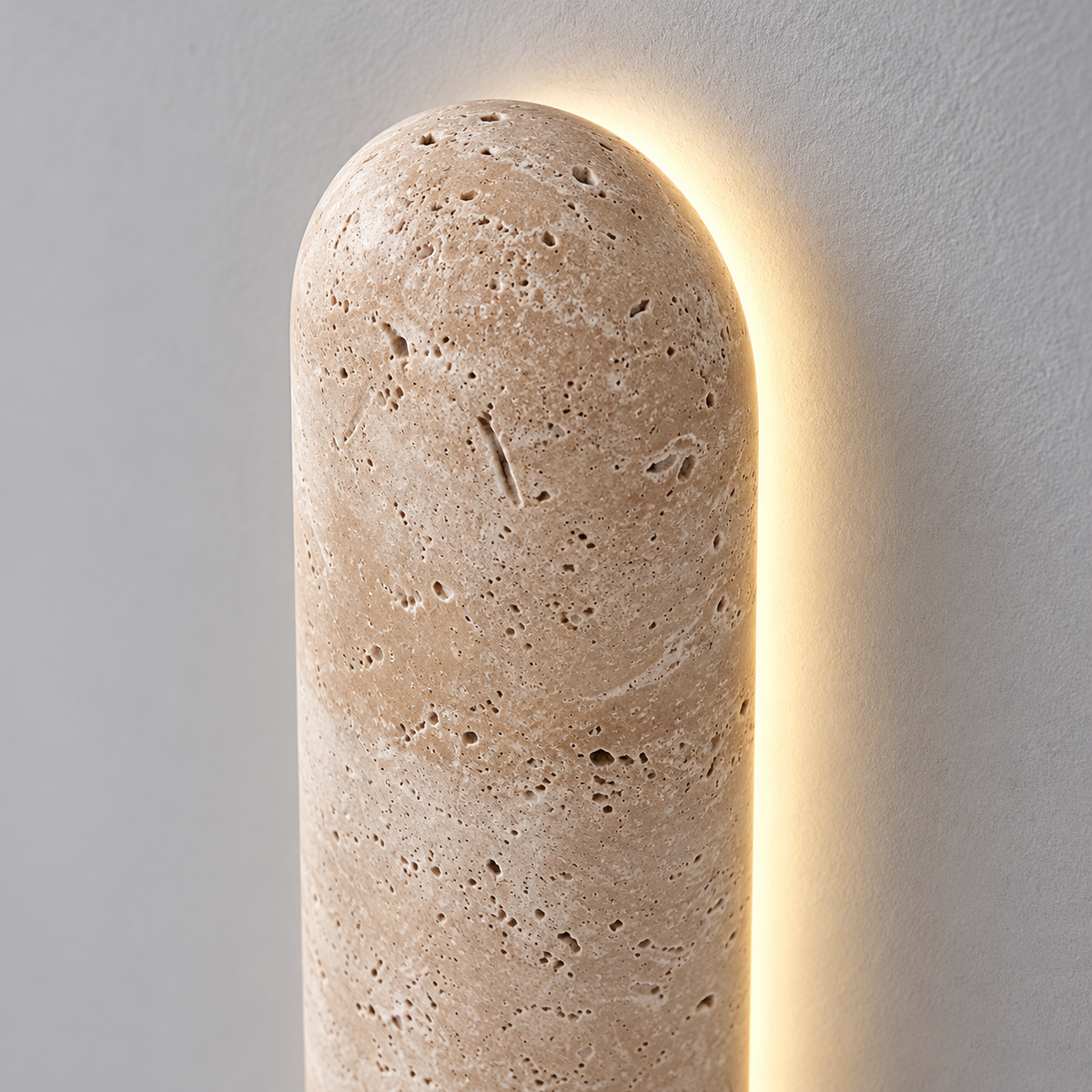 Capsule travertine wall light with a soft halo — detail, Yellow-beige / Length60cm