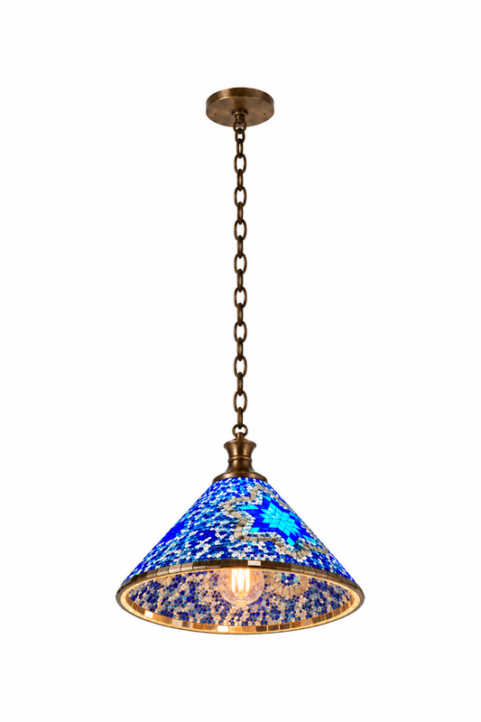 Blue Style A mosaic cone pendant, illuminated from a low opposing view against a clean near-white backdrop, with its inner cone and complete bronze canopy and chain visible.