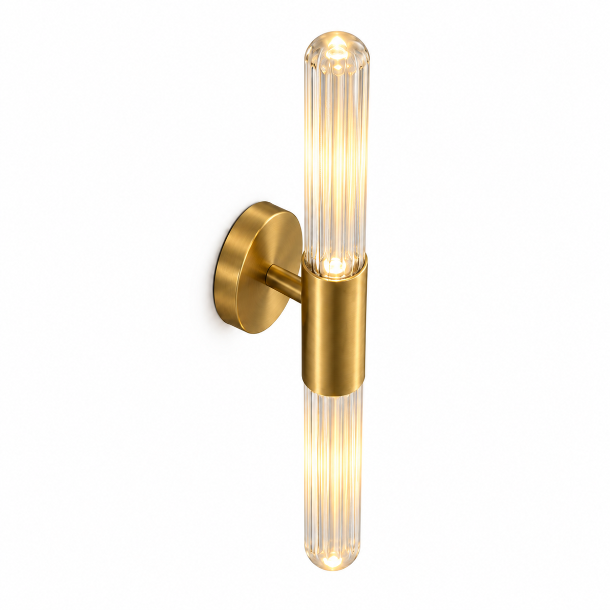 Clear fluted glass and gold wall light, illuminated, photographed from an elevated commercial angle with the upper sleeve entry and rounded glass end visible.