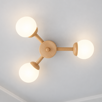 Three-globe wood ceiling light illuminated, photographed directly underneath