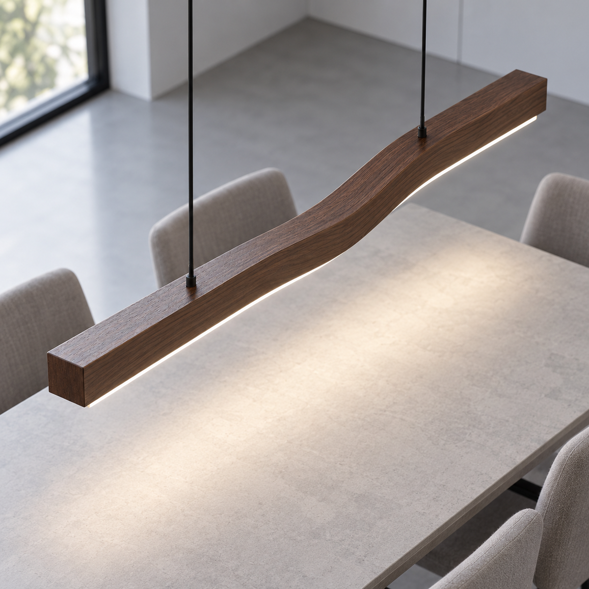 Wood-effect wave pendant seen from above, illuminated over a neutral dining table