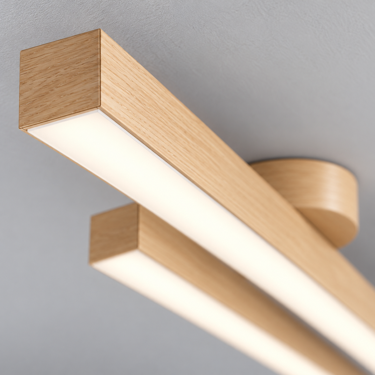 Illuminated acrylic diffuser and light wood effect end seam close-up of twin bar ceiling light