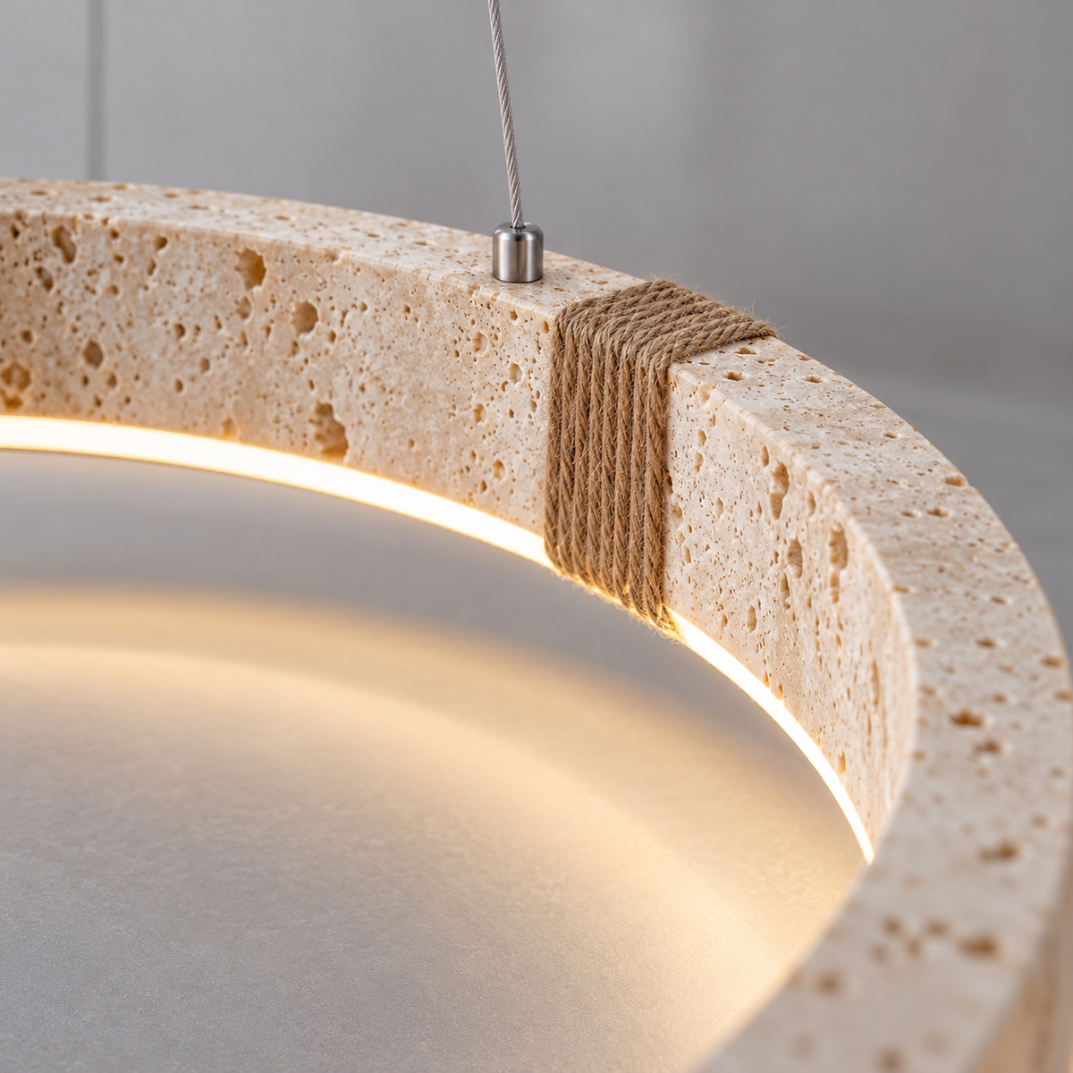 Textured travertine ring pendant with rope detailing — Beige / light wood grain, rope detail on, illuminated and faithfully mounted.