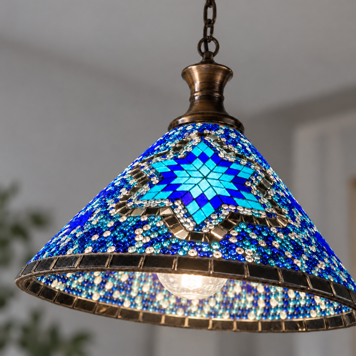 Geometric mosaic glass pendant with a wide cone shade — Style A, detail style a on, illuminated and faithfully mounted.