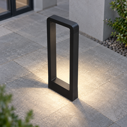 Open frame aluminium garden bollard light — Black, above new, illuminated and faithfully mounted.