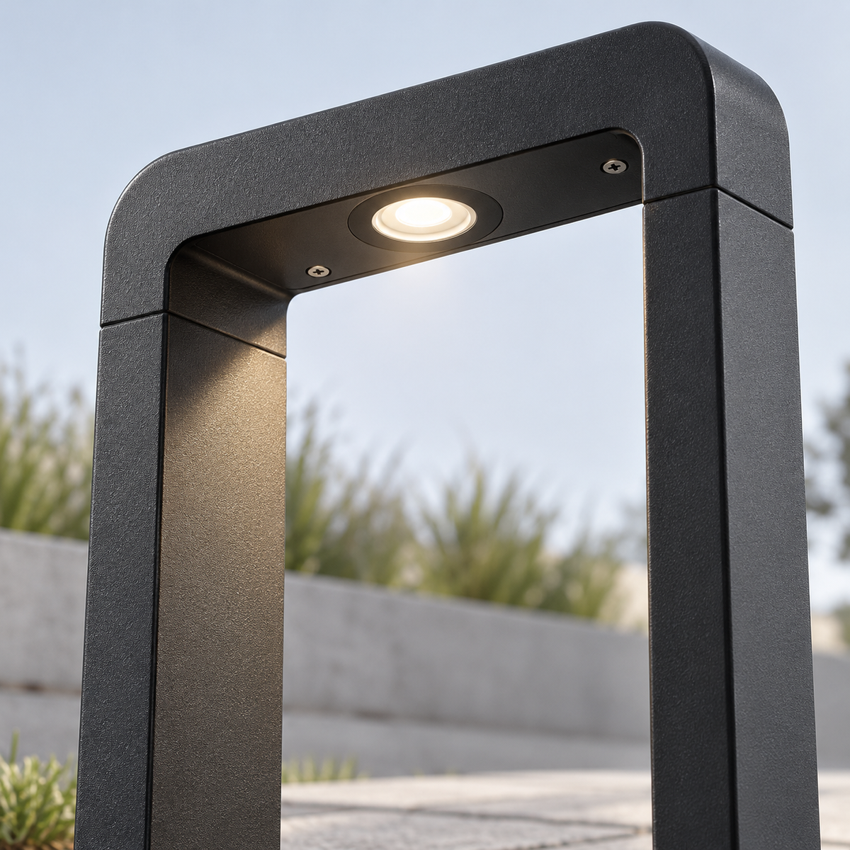 Open frame aluminium garden bollard light — Black, emitter detail, illuminated and faithfully mounted.