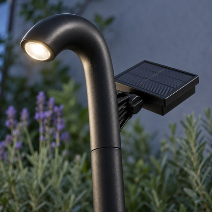 Close side detail of an illuminated arched solar path light showing its lens, panel bracket and hinge