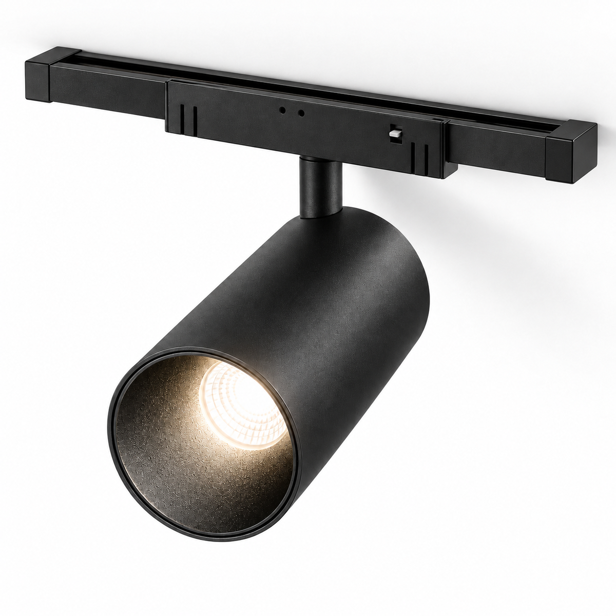Black magnetic track spotlight, complete adapter and short capped track, illuminated elevated studio view
