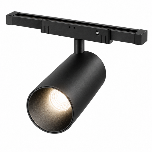 Black magnetic track spotlight, complete adapter and short capped track, illuminated elevated studio view