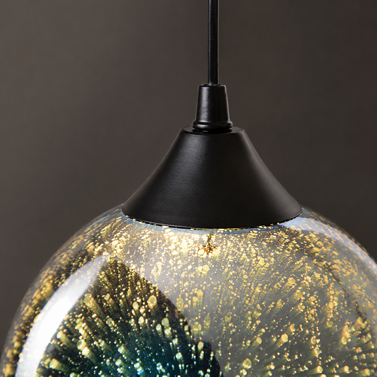 Close-up of the black cap and mirrored glass construction of the pendant light
