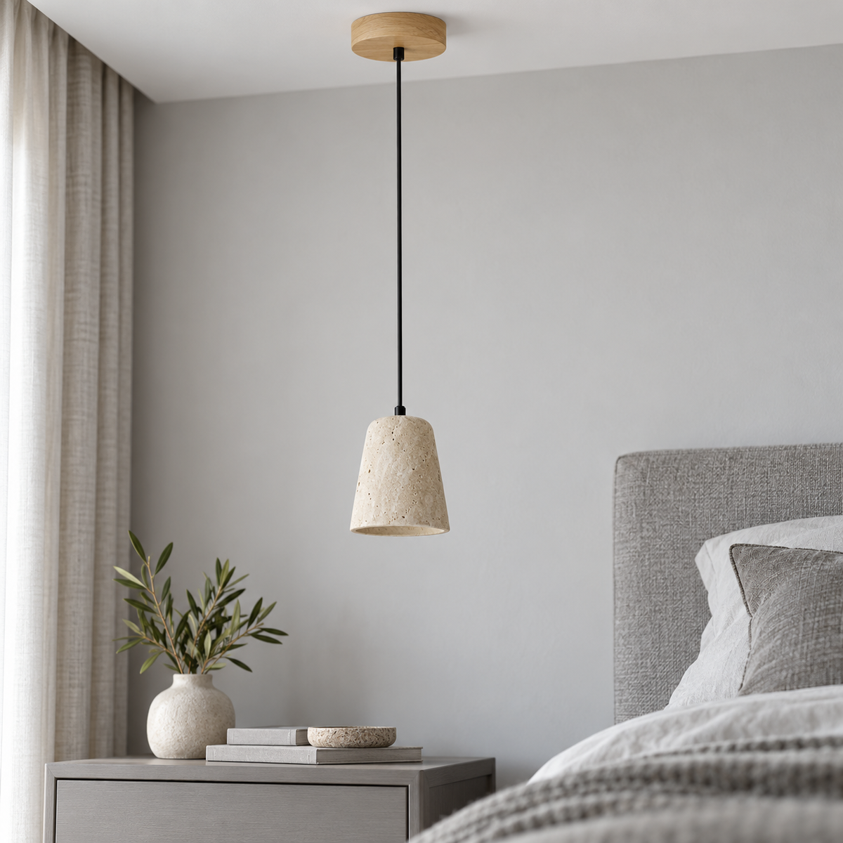 Single travertine pendant with beige wood ceiling canopy, installed in a neutral daylight bedroom
