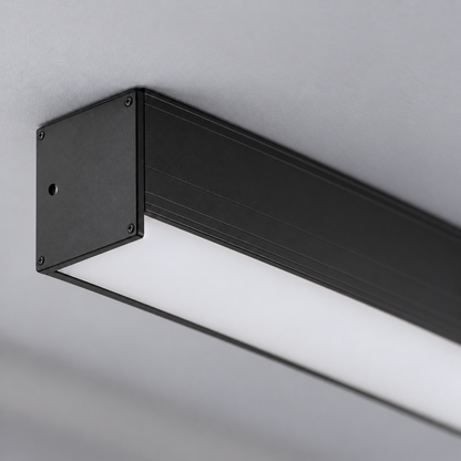 Macro of black aluminium end cap with small fixed fasteners, opening, extrusion lines and unlit acrylic