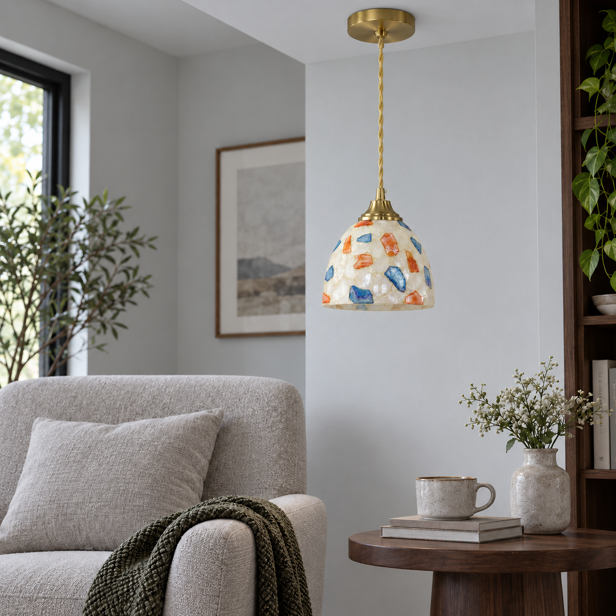 Dome-shaped shell and glass mosaic pendant, model A, installed in neutral daylight with the light off
