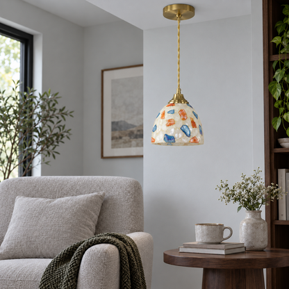 Dome-shaped shell and glass mosaic pendant, model A, installed in neutral daylight with the light off
