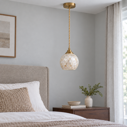 Globe-shaped shell and glass mosaic pendant, model C, installed in neutral daylight with the light off