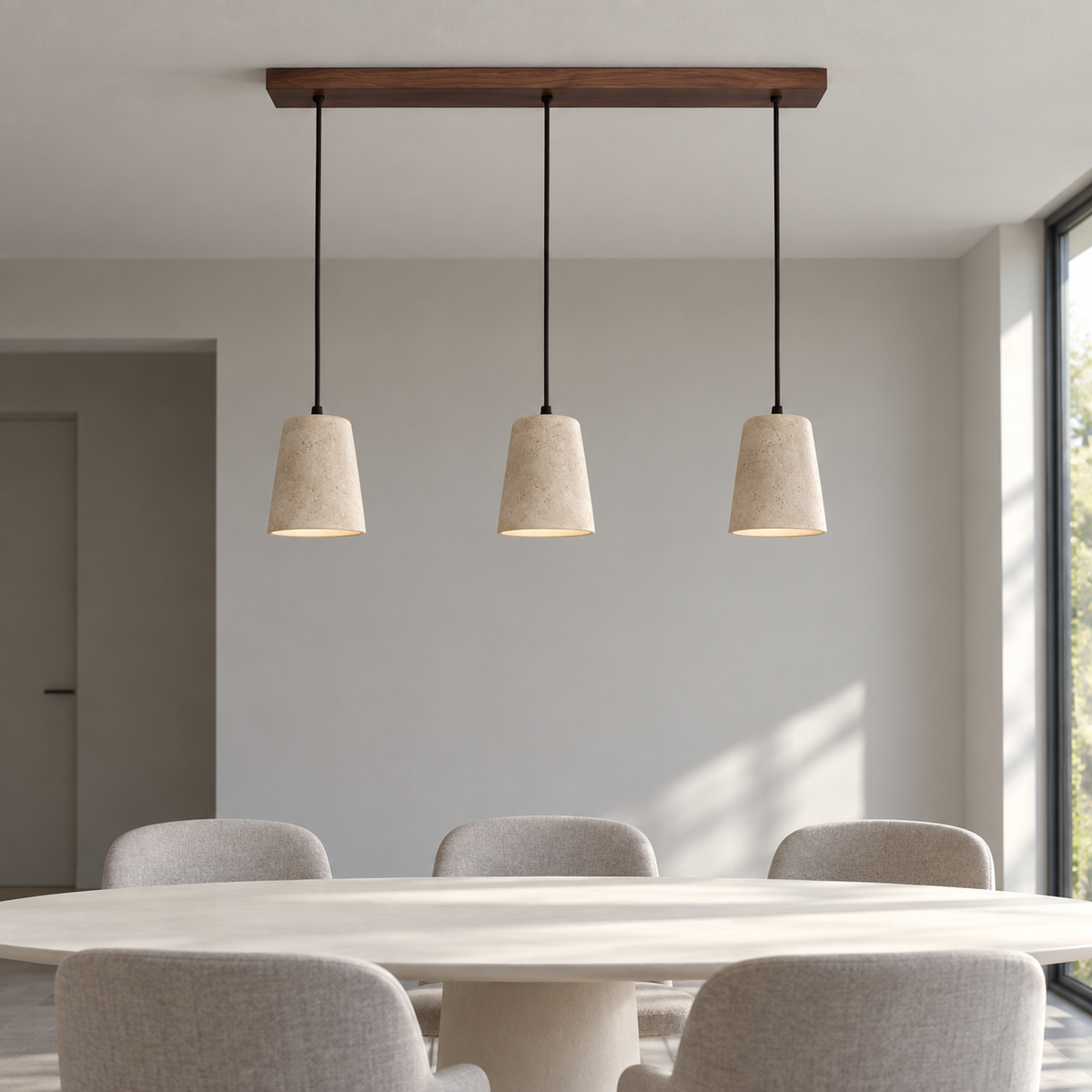 Side view of three travertine pendant shades with walnut wood ceiling canopy in a neutral dining space