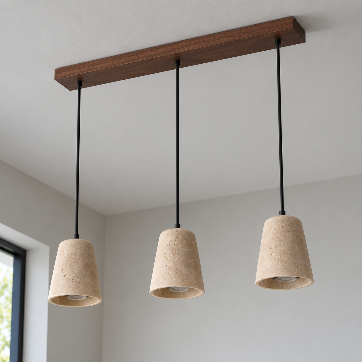 Low angle view of three travertine pendant shades with walnut wood canopy attached to the ceiling