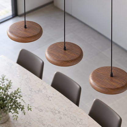 Three walnut-effect disc pendant heads viewed from above, showing their top surfaces and straight row arrangement