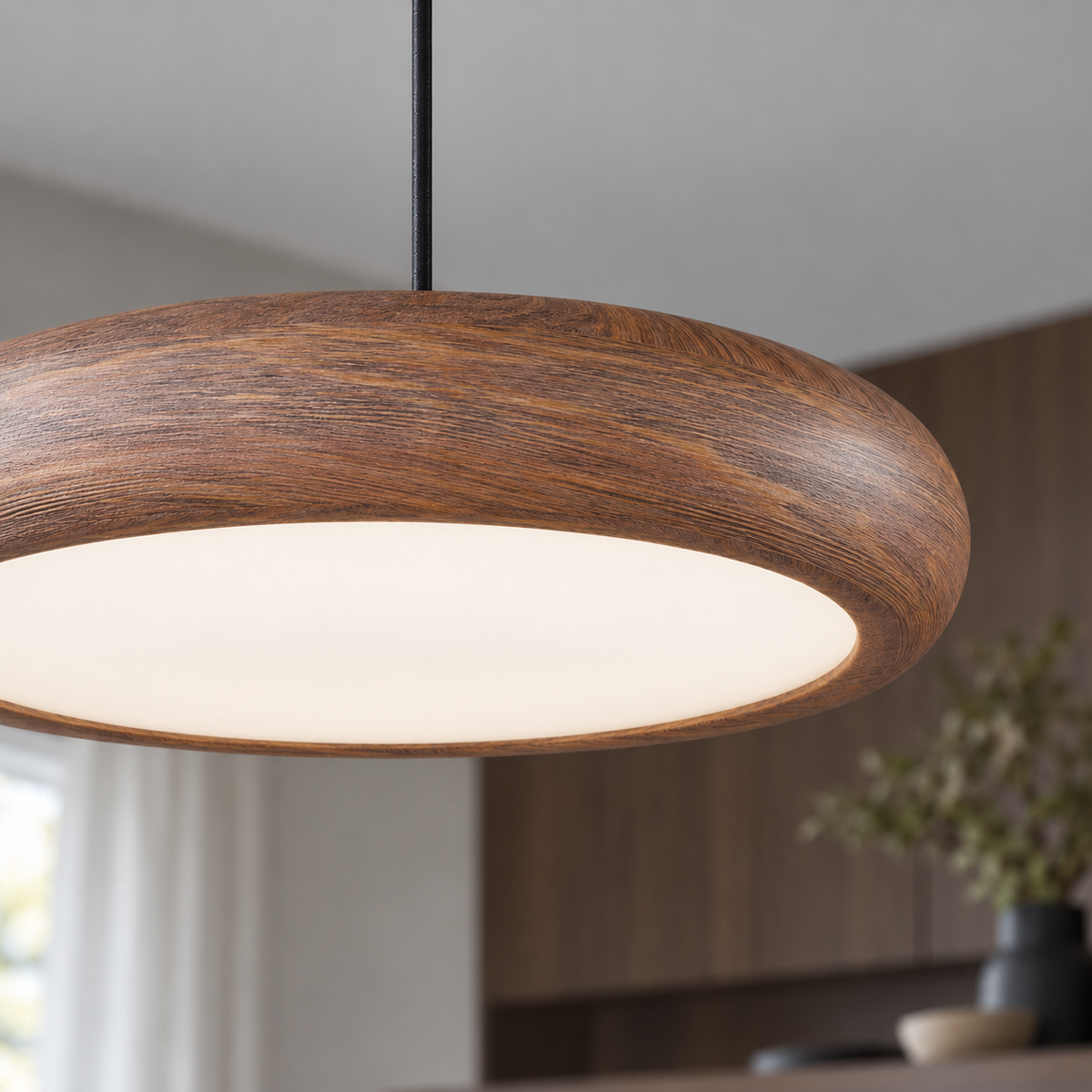 Slim disc pendant in a rich walnut effect finish — detail close