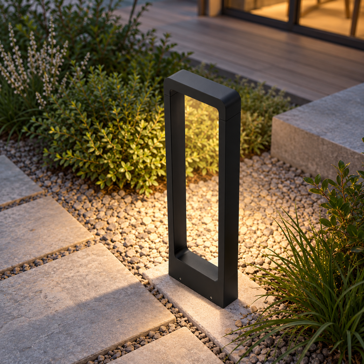 Elevated installed view of the black aluminium garden bollard beside a gravel path