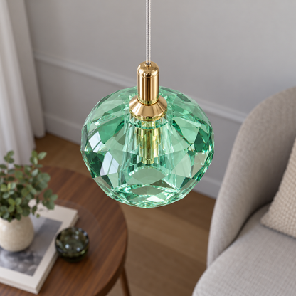 Elevated detail of the green faceted crystal pendant and gold neck