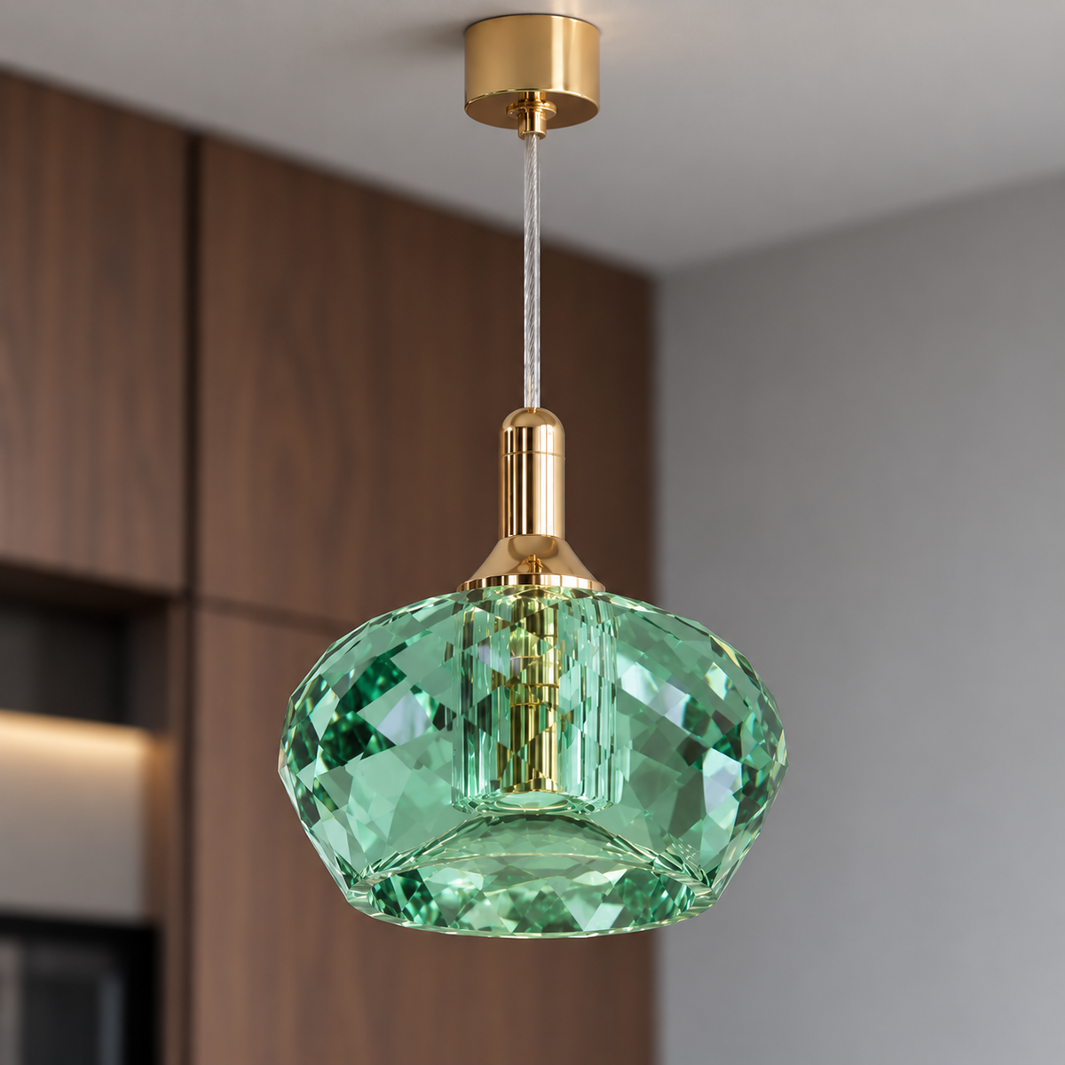 Green faceted crystal pendant, close view of facets and gold fitting