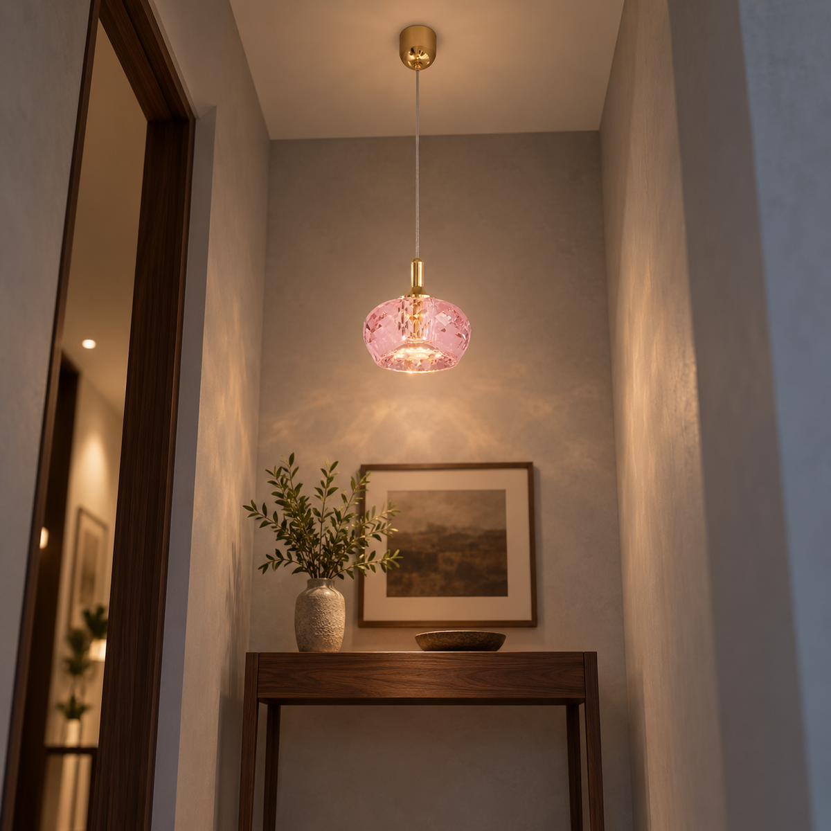 Pink crystal pendant installed above a hallway console, viewed from below