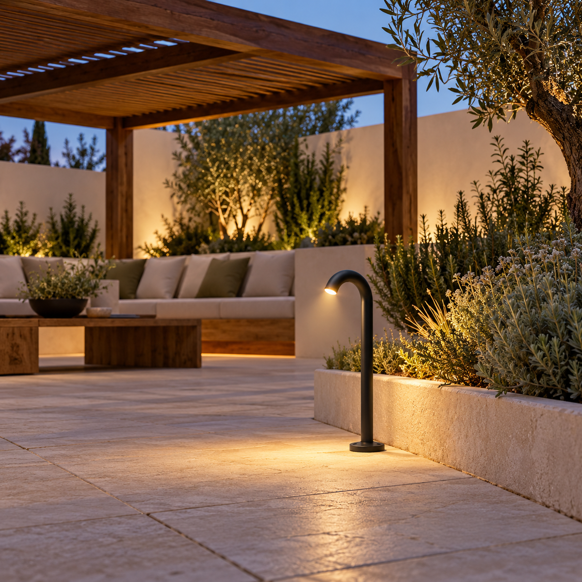 Black curved garden light installed beside a pergola seating area