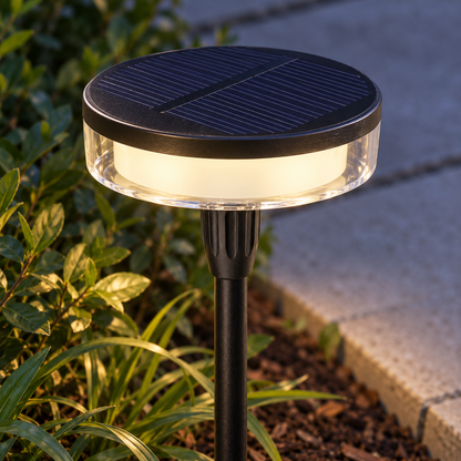 Close-up of the solar panel, clear diffuser and illuminated band of a disc garden light