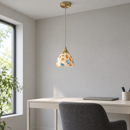 Small multicolour shell and glass dome pendant installed above a desk in neutral daylight