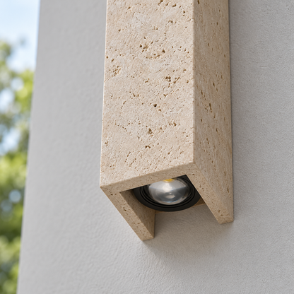 Close-up of travertine wall light showing stone pores and recessed lower COB optic