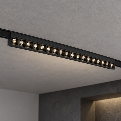 Magnetic fixed grille light 18W, black finish, with eighteen illuminated recessed honeycomb optics, installed in a ceiling track.