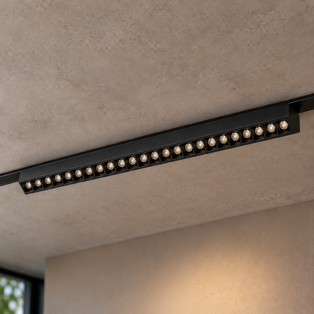 Magnetic fixed grille light 24W, black finish, with twenty-four illuminated recessed honeycomb optics, installed in a ceiling track.