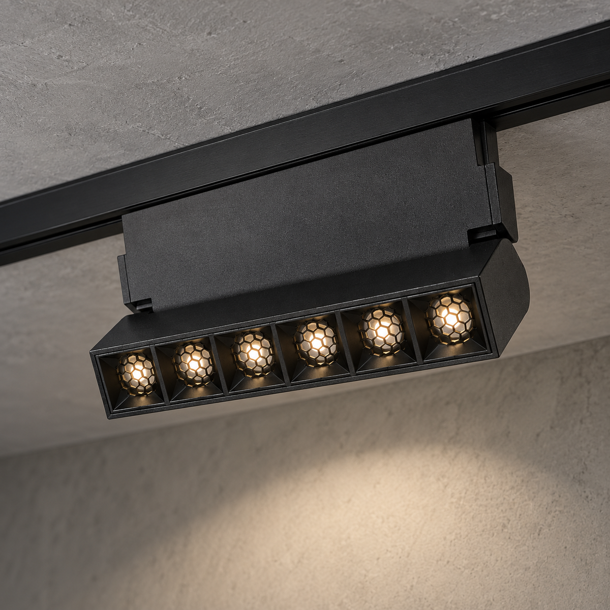 Magnetic folding grille light 6W, black finish, with six illuminated recessed honeycomb optics and visible hinge support, installed in a ceiling track.