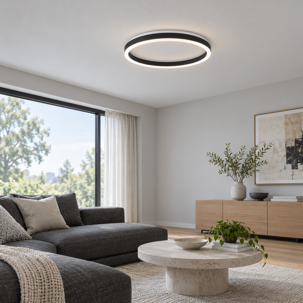 Black round LED ceiling light installed in a modern living room, wide side view