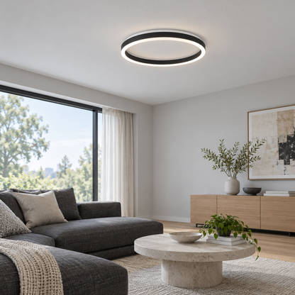 Black round LED ceiling light installed in a modern living room, wide side view