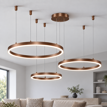Coffee brown bronze LED chandelier with three horizontal illuminated rings measuring 60, 80 and 100 cm, shown in a neutral modern interior.