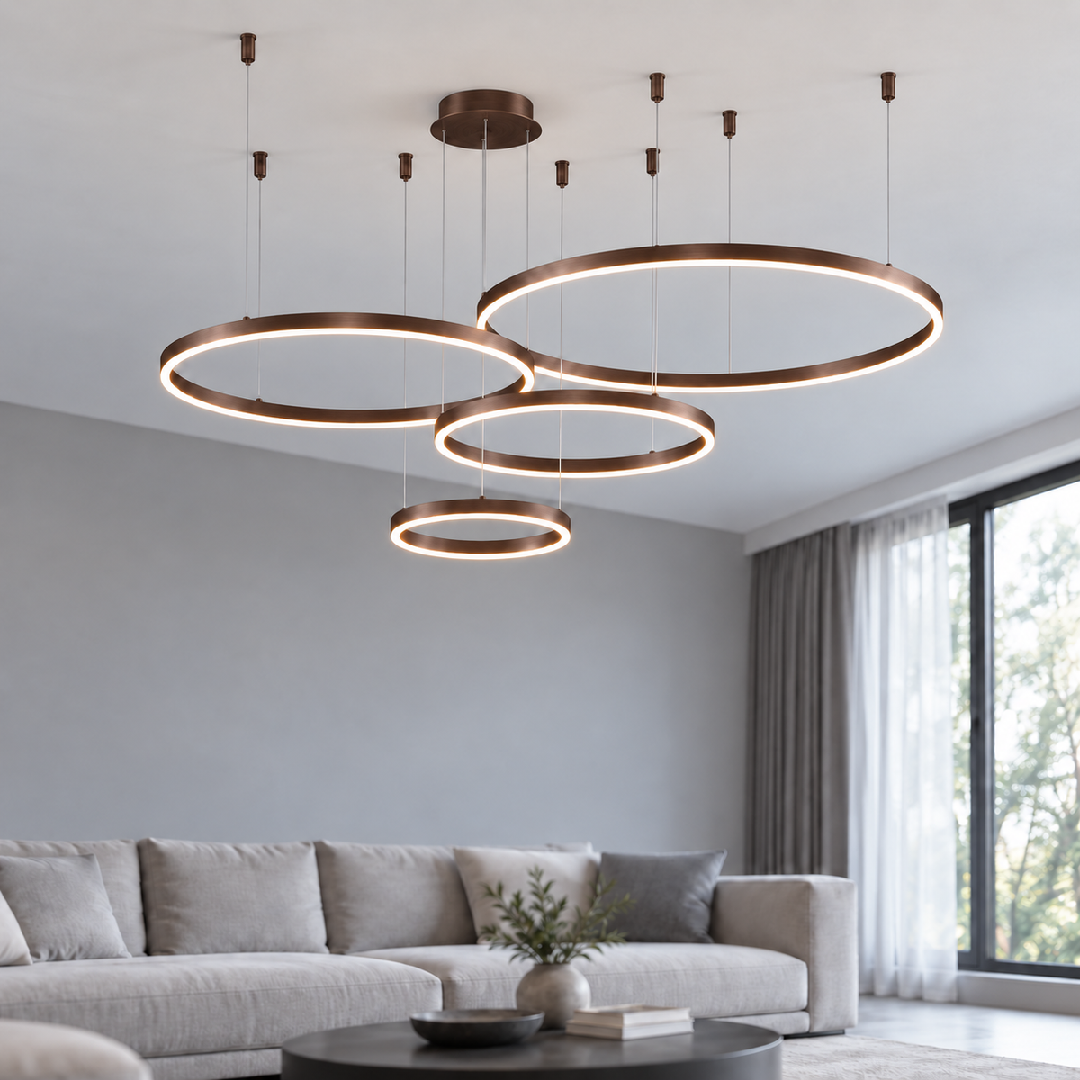 Coffee suspended LED ring chandelier with four offset horizontal rings, 40, 60, 80 and 100 cm diameters, illuminated in a neutral modern living room.