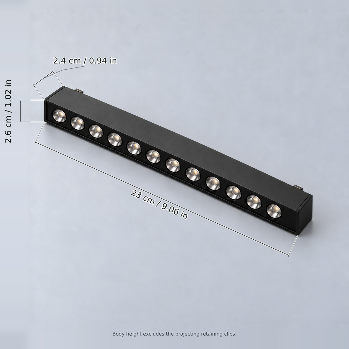 Black grille light 12w with dimension lines in centimetres and inches: Length 23 cm / 9.06 in; Width 2.6 cm / 1.02 in; Body height 2.4 cm / 0.94 in.